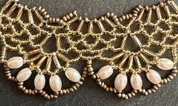 A close up view of a beaded lace necklace.