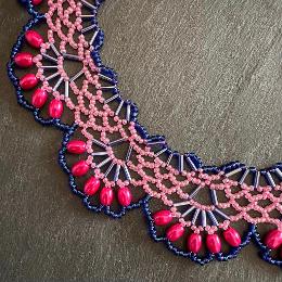 A close up photo of a beaded collar necklace.