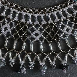 A close up photo of a beaded collar necklace.