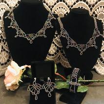 Two necklaces with a bracelet and earrings.