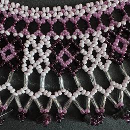 A close up photo of a beaded lace necklace.