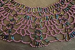 A close up photo of a beaded collar necklace.