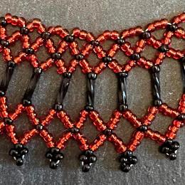 A close up photo of a beaded collar necklace.