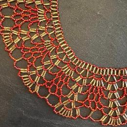 A close up view of a beaded lace necklace.