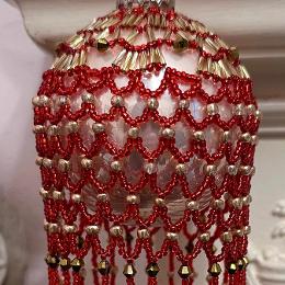 Roaring Twenties bauble. Red and gold beads on a Christmas tree ornament.