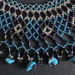 A close up view of a beaded lace necklace.